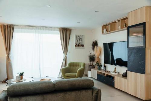 Meuble TV sur mesure associant bois clair, façades effet marbre noir, niches décoratives et porte vitrée striée.
